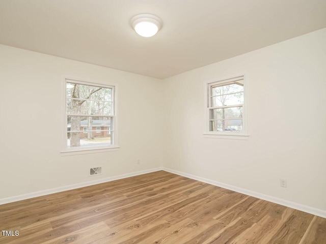 empty room with hardwood / wood-style flooring