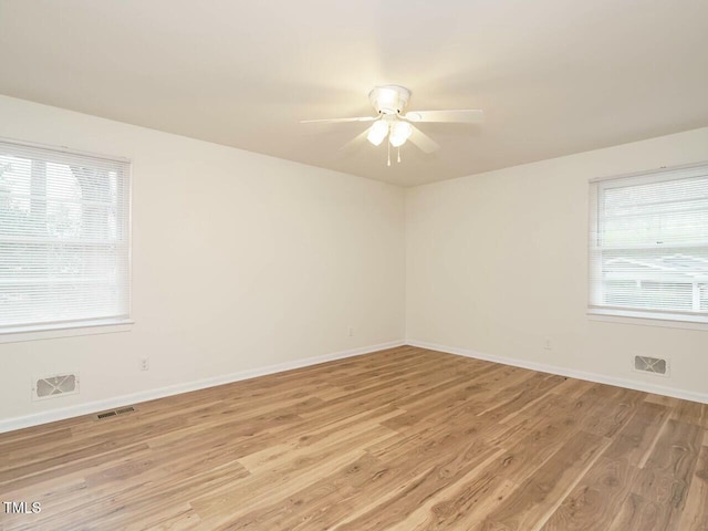 spare room with light hardwood / wood-style flooring and ceiling fan