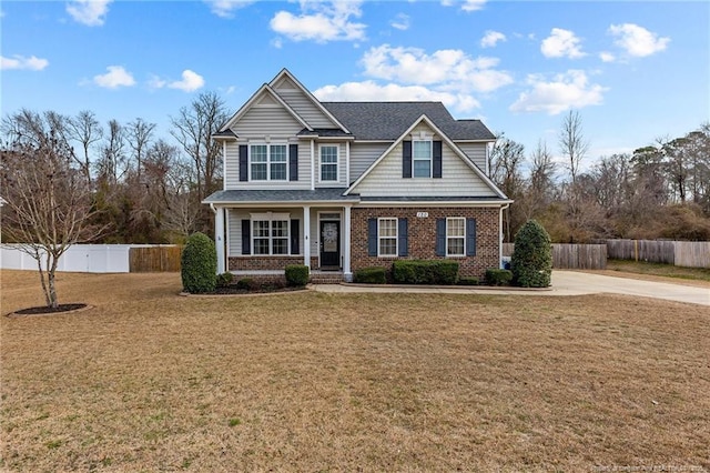 craftsman-style home featuring a front lawn and covered porch