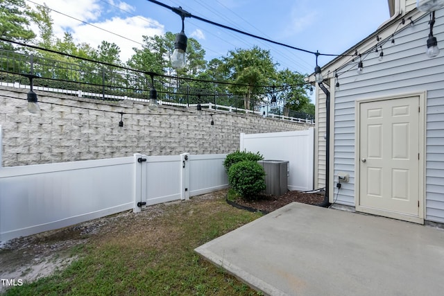 view of yard featuring central AC unit and a patio area