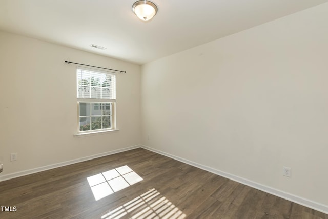 unfurnished room featuring dark hardwood / wood-style flooring