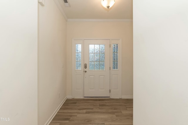 doorway with hardwood / wood-style flooring and ornamental molding