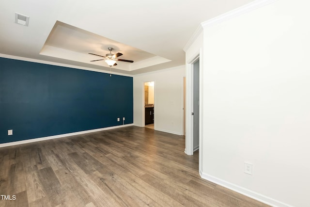 unfurnished room featuring crown molding, ceiling fan, a tray ceiling, and hardwood / wood-style floors