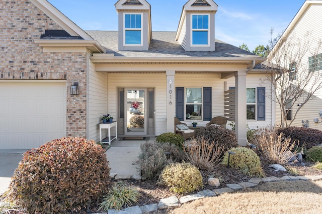 doorway to property featuring a garage and covered porch