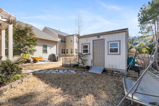 rear view of property with a storage shed