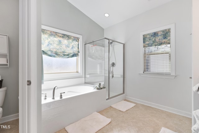 bathroom featuring plus walk in shower, tile patterned floors, and toilet