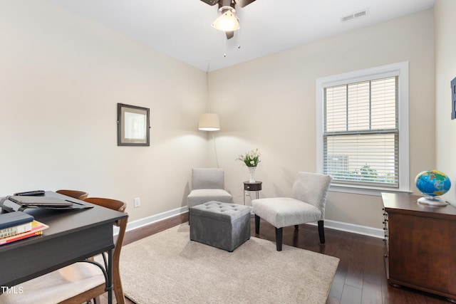 home office with dark hardwood / wood-style flooring and ceiling fan