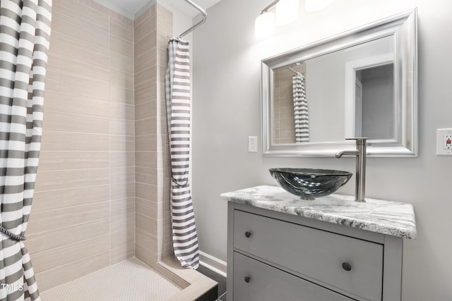 bathroom featuring vanity and tiled shower