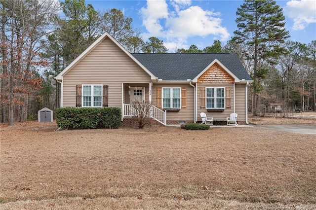 view of front of property featuring a storage shed