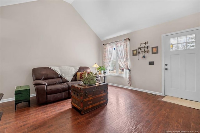 foyer entrance with lofted ceiling and dark hardwood / wood-style flooring