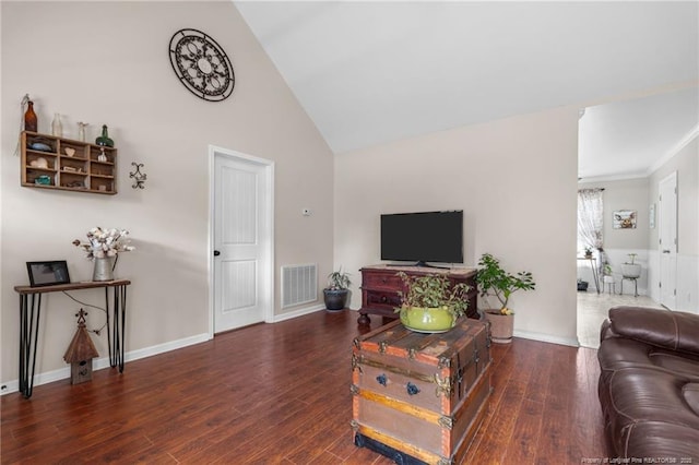 living room featuring dark wood-type flooring and high vaulted ceiling