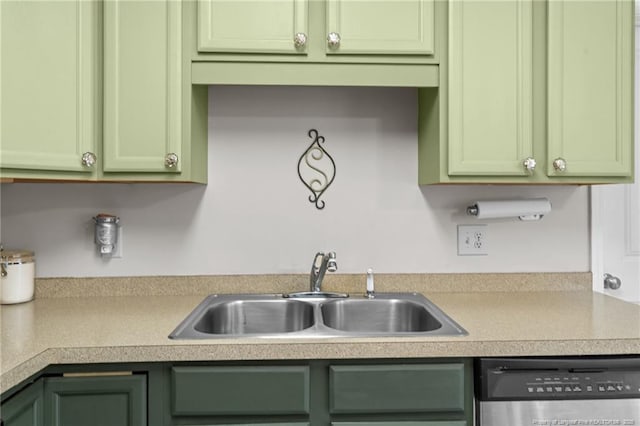 kitchen with sink, stainless steel dishwasher, and green cabinetry