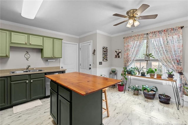 kitchen featuring dishwashing machine, sink, crown molding, green cabinets, and a kitchen island