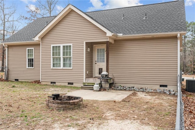 back of property featuring cooling unit, a fire pit, and a patio area