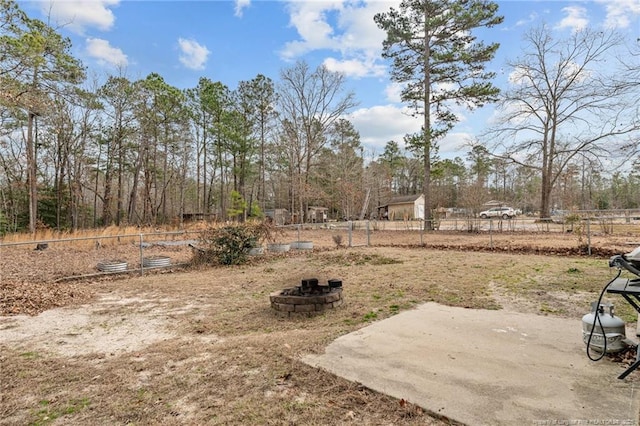 view of yard with a patio area and a fire pit