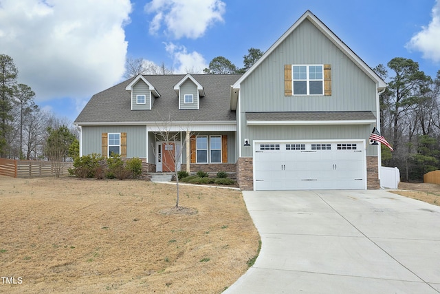 view of front of house featuring a garage and a front lawn