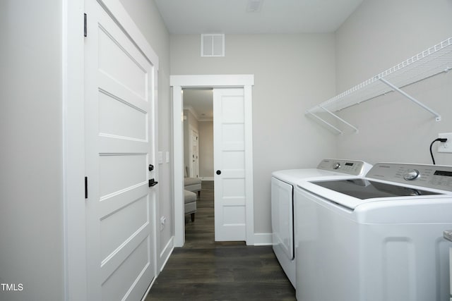 laundry area with dark hardwood / wood-style flooring and washer and clothes dryer