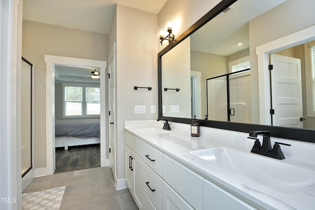 bathroom with tile patterned flooring, vanity, and a shower with shower door