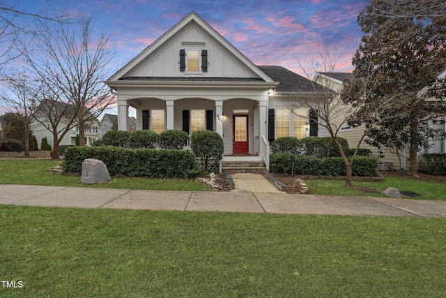 view of front of house featuring a yard and covered porch