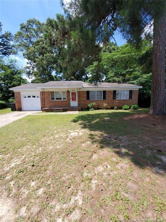 single story home with a garage and a front yard