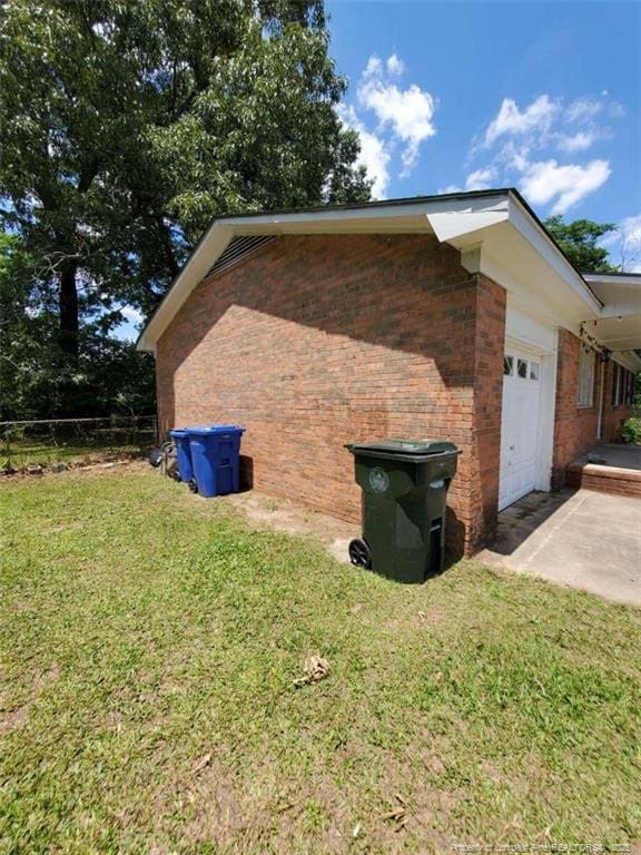 view of home's exterior featuring a yard and a garage