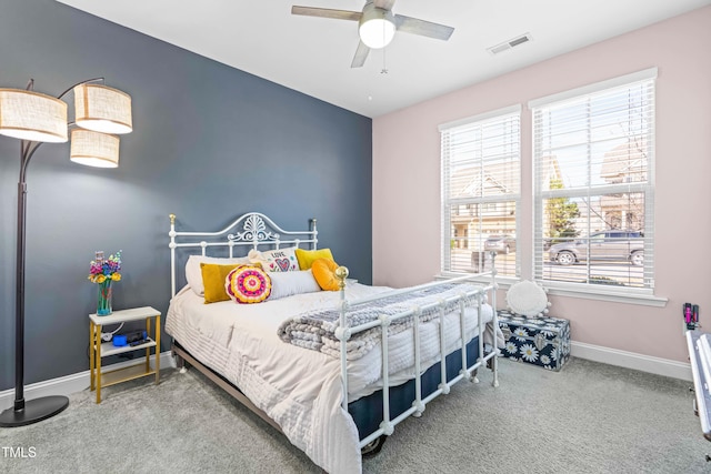 bedroom featuring a ceiling fan, carpet flooring, visible vents, and baseboards