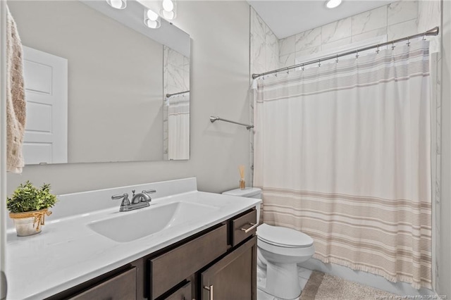 bathroom featuring vanity, toilet, and walk in shower