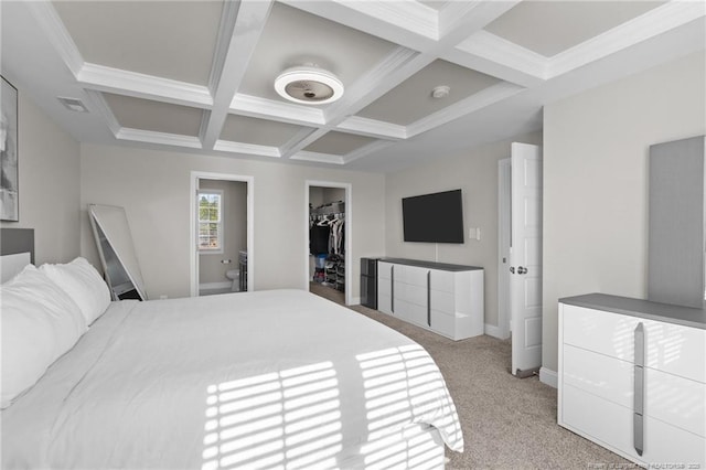 carpeted bedroom with a walk in closet, coffered ceiling, a closet, and beam ceiling