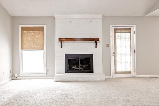 unfurnished living room featuring a fireplace and carpet floors