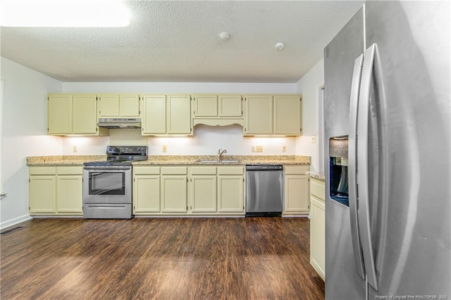 kitchen with dark wood-type flooring, appliances with stainless steel finishes, sink, and a textured ceiling