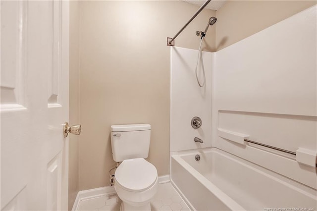 bathroom featuring tile patterned flooring, bathtub / shower combination, and toilet