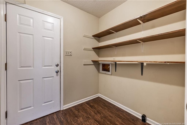 laundry room featuring washer hookup, dark hardwood / wood-style flooring, and a textured ceiling