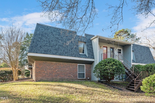 rear view of property with a yard and ceiling fan