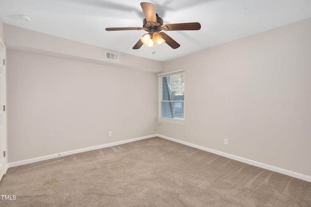 carpeted empty room featuring ceiling fan