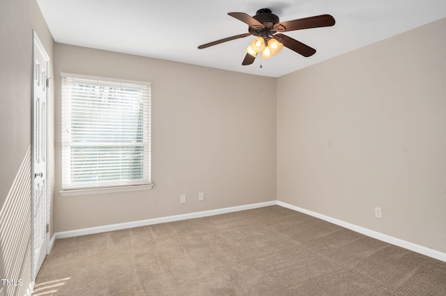 carpeted empty room featuring ceiling fan