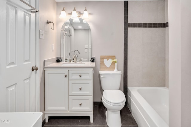 full bathroom with tile patterned flooring, vanity, tiled shower / bath, and toilet