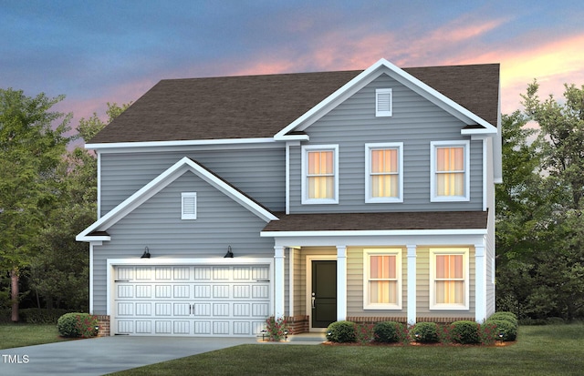 view of front facade featuring a garage and a yard