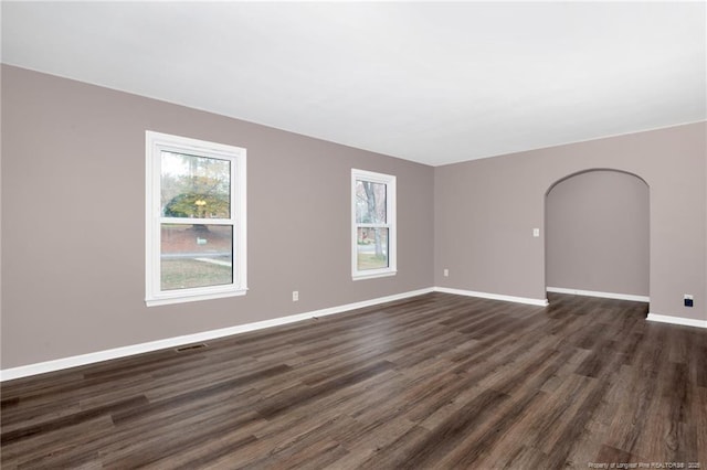 empty room with dark wood-type flooring