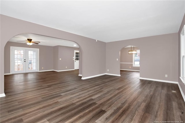 unfurnished living room with french doors, ceiling fan, and dark hardwood / wood-style flooring