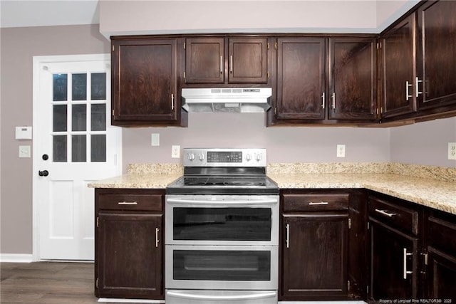 kitchen featuring dark brown cabinets, dark hardwood / wood-style floors, and range with two ovens