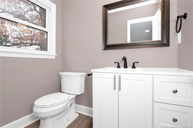 bathroom featuring hardwood / wood-style flooring, vanity, and toilet