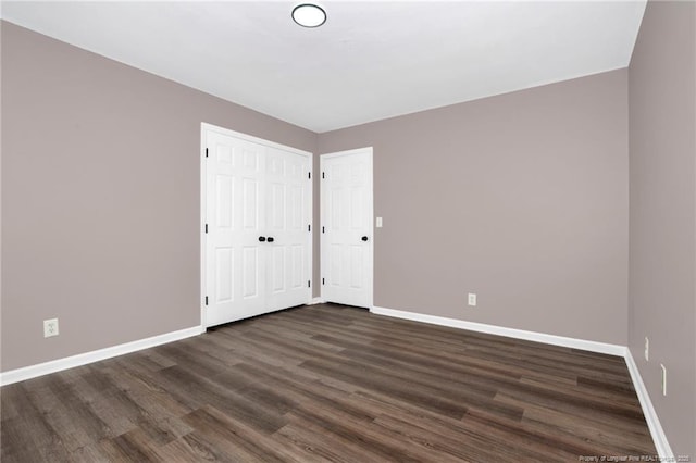 unfurnished room featuring dark wood-type flooring