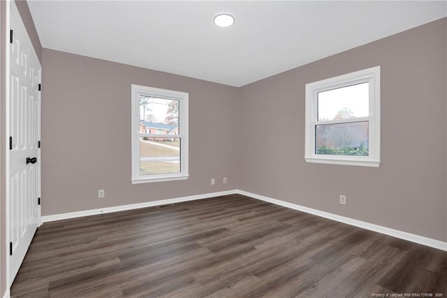 unfurnished room featuring dark hardwood / wood-style floors