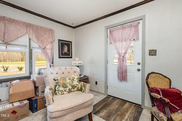 entryway with ornamental molding, a healthy amount of sunlight, and dark hardwood / wood-style flooring