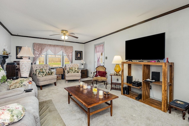 living room with a textured ceiling, ornamental molding, ceiling fan, and carpet