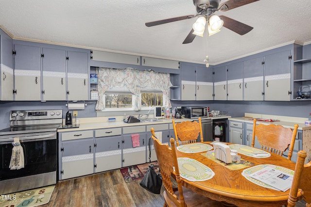 kitchen with appliances with stainless steel finishes, dark hardwood / wood-style floors, sink, ceiling fan, and a textured ceiling