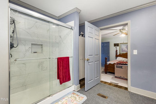 bathroom featuring ornamental molding, ceiling fan, and a shower with shower door