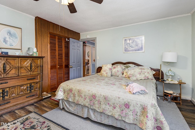 bedroom featuring ornamental molding, a textured ceiling, dark hardwood / wood-style flooring, and a closet