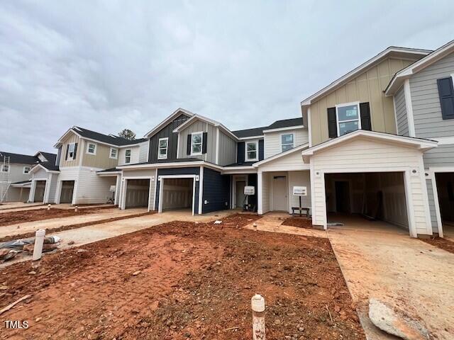 view of front of house with a garage, driveway, and board and batten siding