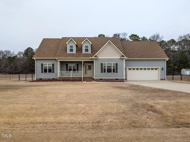 view of front facade featuring a garage, a front yard, and covered porch